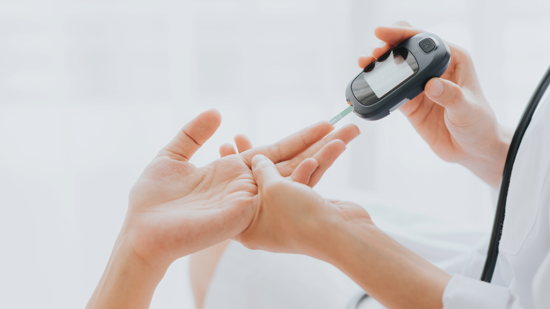 Healthcare professional checking blood sugar with glucose meter.